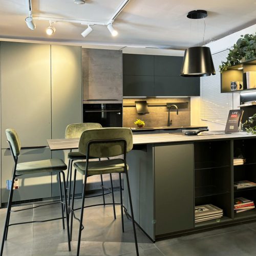 Cucina moderna Life con isola centrale, sgabelli, illuminazione led e piante decorative